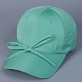 Detail showing mint green satin baseball cap with a decorative matching bow on the brim - M (56-58cm) / Emerald