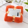 Orange coral fleece face towel tied with gold ribbon and premium gift tag detail - Orange