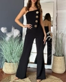 Detail of slim-fit black strapless jumpsuit featuring four decorative gold embossed buttons - S / Black