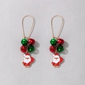 Detail shot of Santa Claus earrings with festive red and green bells on golden hooks - Santa Claus & Bells Long Dangle