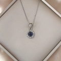 Macro view of sapphire blue pendant necklace with sparkling white zircons on silver chain - Silver Blue Zirconia
