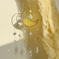 Close-up of golden moon suncatcher with yellow crystals and rainbow reflections - Citrine Moon Wind Chime