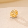 Macro detail of gold spacer bead with zircon inlay, size 0.7cm by 0.3cm for DIY crafts - Gold Textured Zirconia