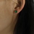 Minimalist small round green resin stud earrings worn on ear for women - 5mm / Green