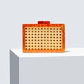 Chic green rattan and amber acrylic evening clutch bag on white geometric steps - Orange Red