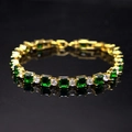 Detail of gold tennis bracelet with square green and round clear cubic zirconia stones - Gold Plated Green