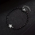 Beaded bracelet with black obsidian stones and a silver star pendant with metal clasp - Silver Star