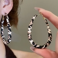 Detail of zebra pattern drop earrings with gold hooks worn and held by a model - 47# 925 Sterling Silver Earring Post - Brown - Teardrop
