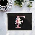 Black canvas cosmetic bag with floral letter F print and a metallic zipper closure - Letter F