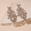 Close-up of luxury silver drop tassel earrings with sparkling rhinestones on stone base - Silver Pattern Water Drop Earrings
