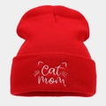 Close-up of Cat Mom embroidery and cat whiskers on a red ribbed knit beanie hat - One Size / Red