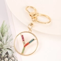 Detail of golden metal keychain featuring letter Y pendant with colorful rhinestones - Letter Y