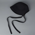Detailed flat lay of a black handmade knit bonnet hat with tie strings on grey background - M(56-58cm) / Black