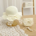 Close-up of woven straw hat and matching purse with lace bows on a rustic wooden table - 52cm 3-6 Years / Set-Cream White