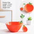 Ceramic tomato shaped bowl with matching spoon in vibrant orange finish and leaf detail - Tomato Shape