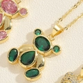 Golden bear pendant necklace featuring emerald green zircon with a polished finish - Emerald Green Zircon Bear