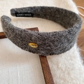 Detail showing wool texture, handmade label and golden metal logo on wide headband - Gray