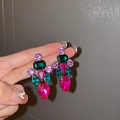 Macro shot of colorful rhinestone earrings featuring rose, green, and purple gemstones - Colorful Silver Needle Style