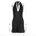Detailed view of polka dot halter dress featuring a deep V-neck and ruffled hemline - S / Black