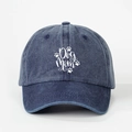 Close-up of vintage washed navy cotton baseball cap with white Dog Mom text and paw prints - Adjustable / Navy Blue