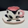 Detail of irregular ceramic coffee cup with cow print patterns and pink handle - 250ML / Cow Print