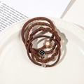 Detailed view of high-elasticity brown hair ties with metal heart and floral charms - 4Pcs Set - Pineapple Style / Brown