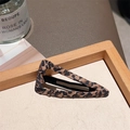 Triangle leopard print hair clip for women displayed on a natural wood tray - Leopard Fabric Wrapped Triangle Clip