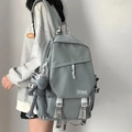 Detail of the grey-green backpack side view featuring a cute monkey keychain and logo - No Pendant / Blue