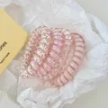 Set of 4 pink and white spiral hair ties with diverse textures on wrinkled paper - 2# Pink 4-Piece Set