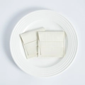 Detail of cream microfiber jewelry pouches with flap closure on a white ceramic plate - 8*8cm / Off White