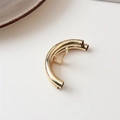 Detailed close-up of golden lava-style metallic hair clip with smooth polished finish - Double Row Tube Gold