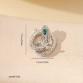 Macro detail of silver snake pendant with green gem and white cubic zirconia accents - Pave Rhinestone Snake Style (MYYX00694) / Silver-Green Zirconia