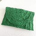Detailed close-up of green woven paper straw envelope clutch bag with vibrant texture - Green