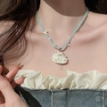 Close-up of ocean-style shell pendant necklace with blue beads and pearls on model - Light Blue Beads White Shell Tassel (20#)