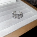 Detailed view of irregular grain texture and zircons on a silver open ring band - Irregular Texture White Zirconia Inlay Style / Silver