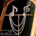 Detail of silver musical note brooches with sparkling rhinestones and layered tassel chains - Silver Music Note Style (TL24057)