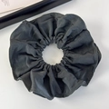 Detailed texture of dark grey double-layered pleated fabric hair scrunchie on a white desk - Green Black