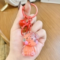 Pink and red Hello Kitty liquid sand backpack keychain with cute cookie charm and ring - Red Hello Kitty Milk Bean
