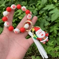 Detail of red and white silicone beaded keychain with Santa charm and white tassel - Style 6 (3D Santa Claus Figure)