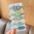 Detailed view of five blue polka dot hair ties with decorative bows and floral charms - Light Blue Series 5-Piece Set