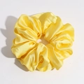 Close-up of yellow satin scrunchie showing glossy silk texture and elegant pleats - Yellow Large