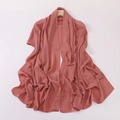 Silky pink chiffon headscarf with soft drapes and smooth texture on wooden hanger - Crimson