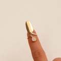 Golden nail ring featuring a teardrop-shaped zircon inlay on a polished metal surface - Teardrop Pave Zirconia Ring (S605)