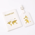 Close-up of white PU leather passport holder and luggage tag with gold world map pattern - White Map