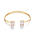 Golden stainless steel cuff bracelet featuring two square-cut cubic zirconia gemstones - White Round