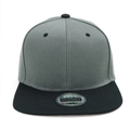 Detail view of two-tone snapback cap with silver quality seal and breathable eyelets - Black Brim Dark Gray Hat