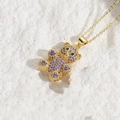 Chic 14K gold plated bear necklace with purple zircon inlay on a white stone background - Gold/Purple Zirconia