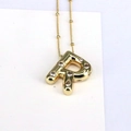 Macro detail of 18k gold R-letter bubble pendant with cubic zirconia on dudu chain - Letter R