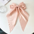 Champagne pink satin bow hair clip with long ribbons on a minimalist white surface - Champagne Pink