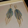 Close-up of golden tassel earrings with gradient blue and green crystals and rhinestones - Green-Blue U-Shaped Ear Hook